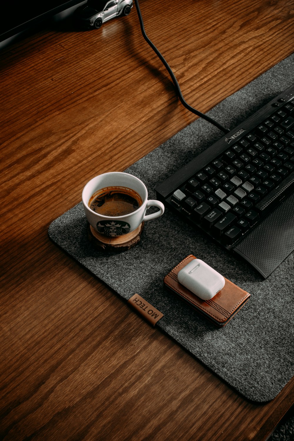 a cup of coffee next to a keyboard