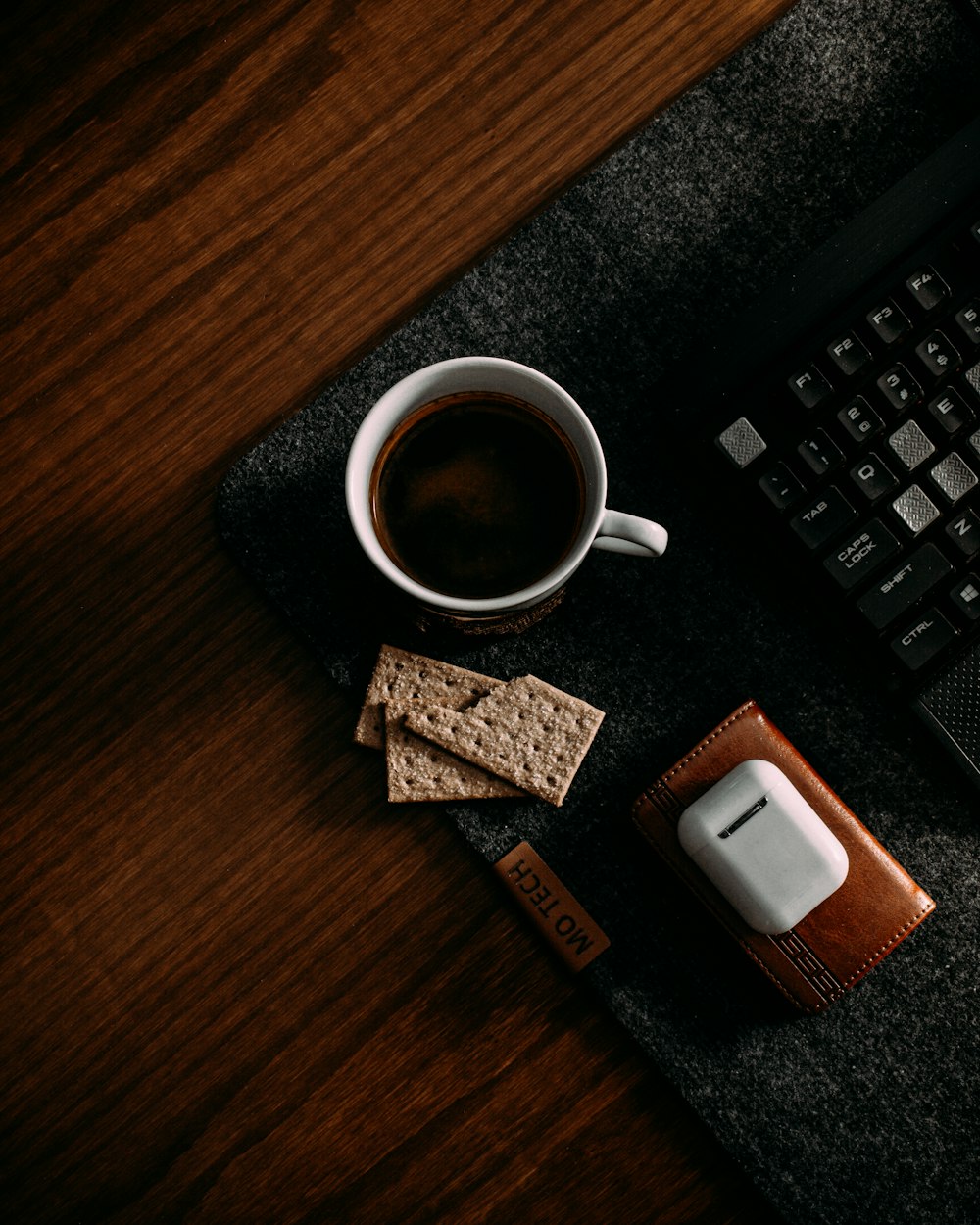 a cup of coffee and a cell phone on a desk