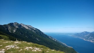 A scenic mountain view with a clear lake in the foreground.