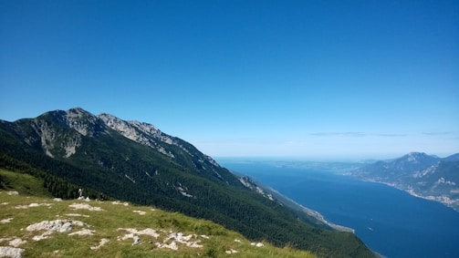 A scenic mountain view with a clear lake in the foreground.