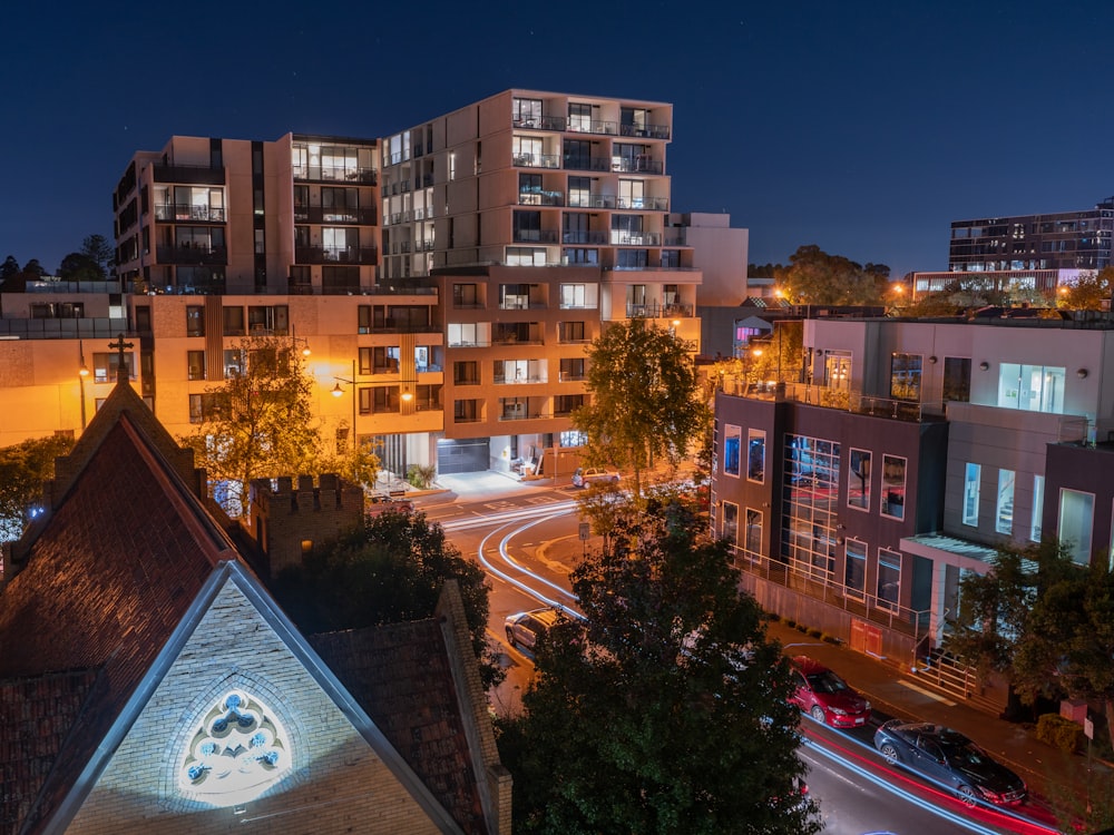 a building with a parking lot and trees in front of it