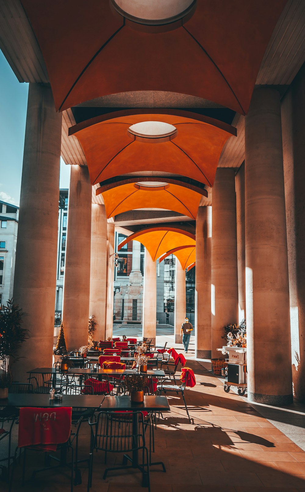 a group of tables and chairs outside a building