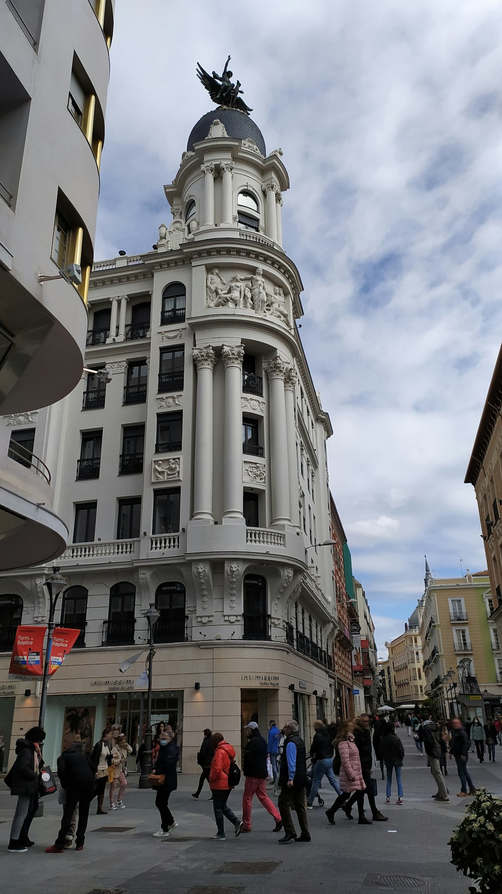 a large building with a statue on top of it