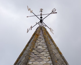 a weather vane on top of a building