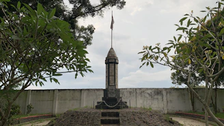 a tall tower with a flag on top