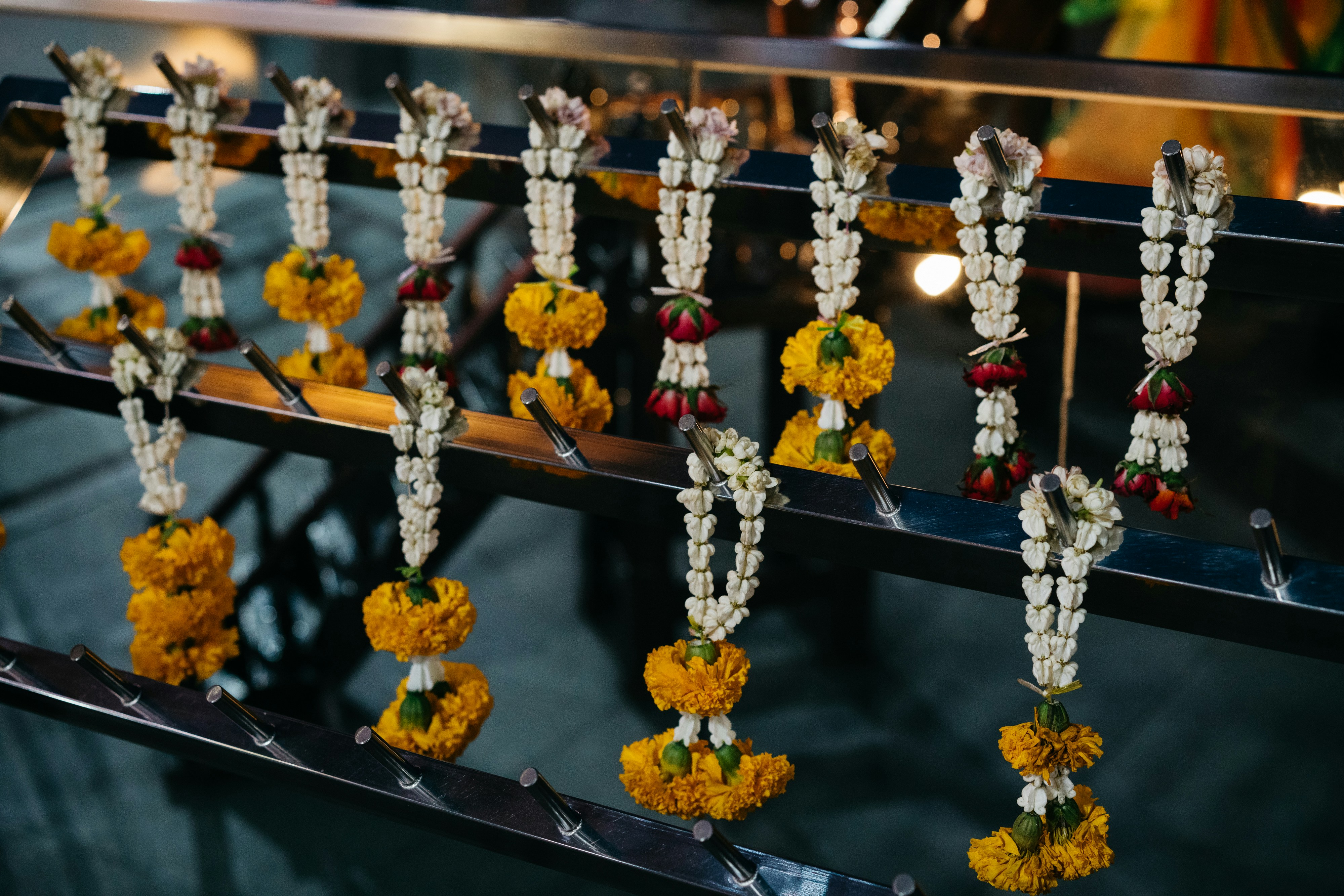 Jasmine and marigold garlands draped over marble pillars