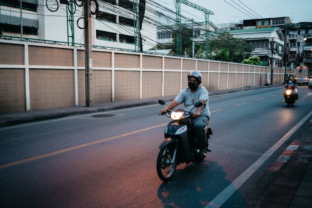 a person riding a motorcycle down the street