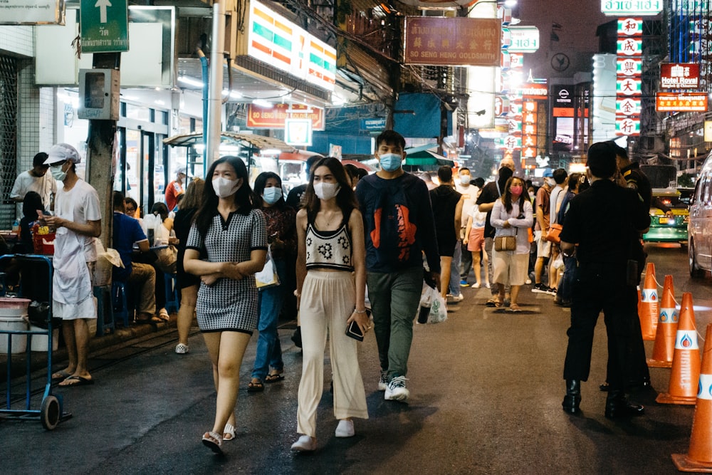 a group of people walking in a busy street