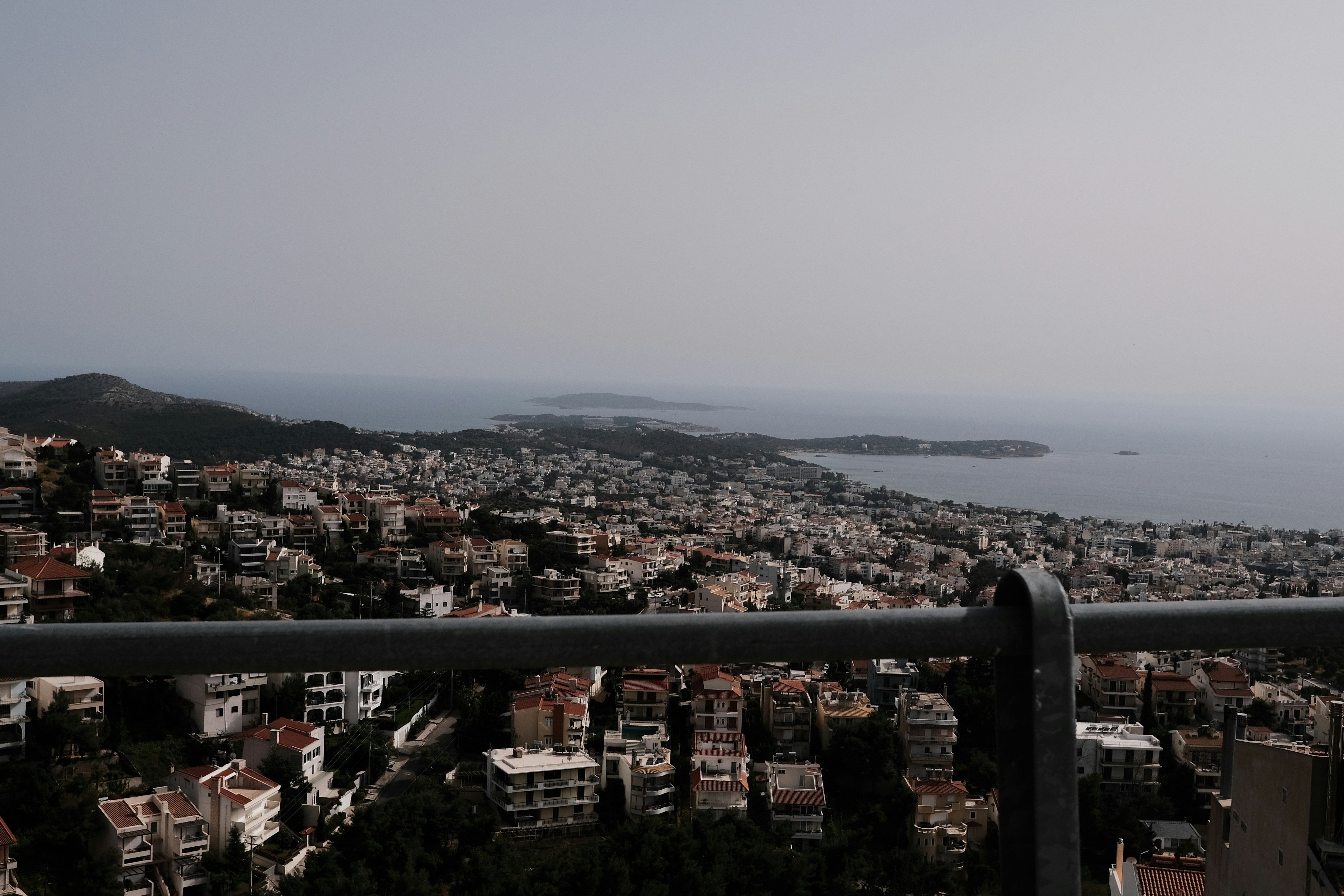 a city with a body of water in the background