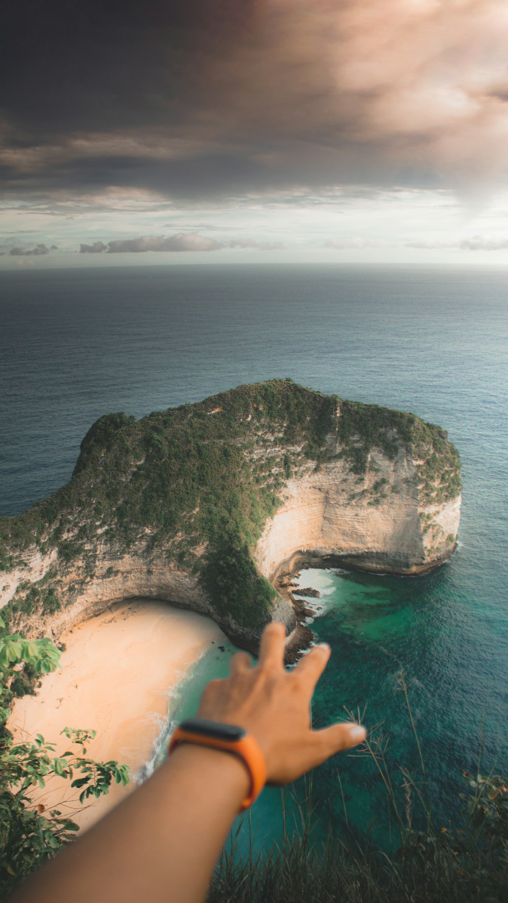 a hand holding a rock above water