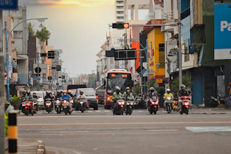 a group of motorcyclists ride down a city street