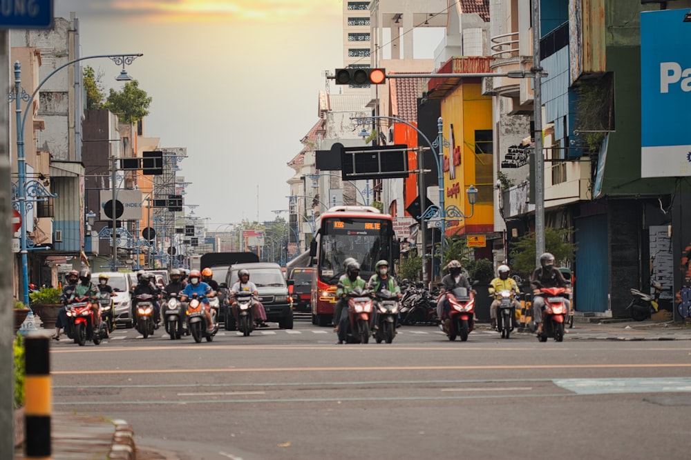 a group of motorcyclists ride down a city street