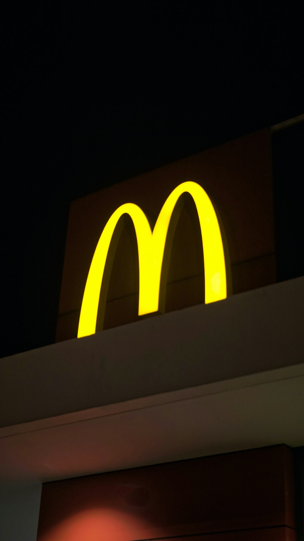 a yellow logo on a wall