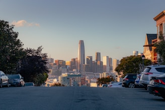 a city skyline with cars parked in front of it