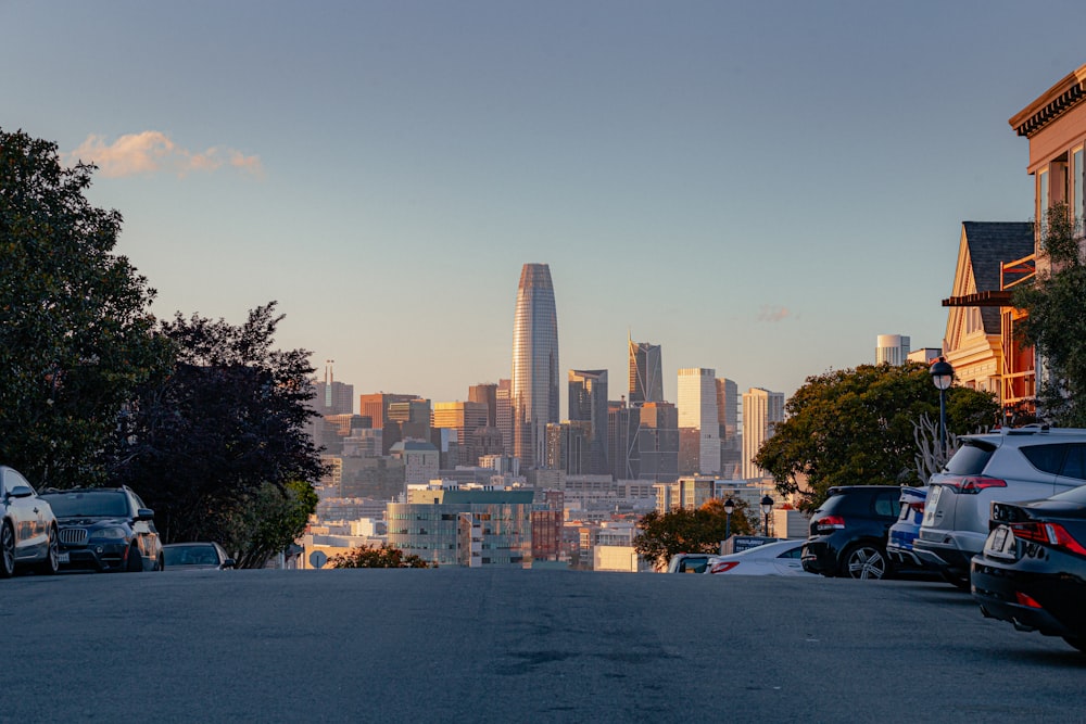 a city skyline with cars parked in front of it