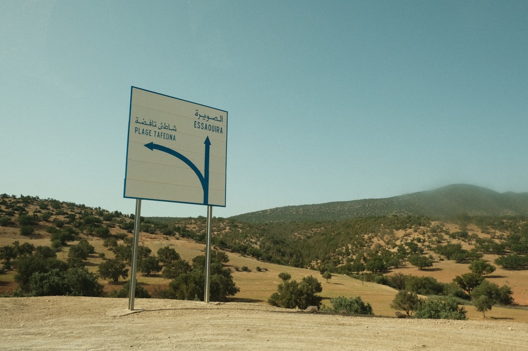 a sign in the desert, A sign showing the way in Morocco