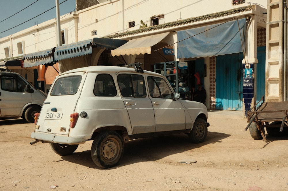 a white car parked in front of a store