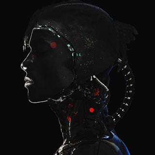 A silhouette of a human-like figure with cybernetic elements, featuring illuminated circuits and lights. The profile is dark with prominent bright accents highlighting the futuristic design.