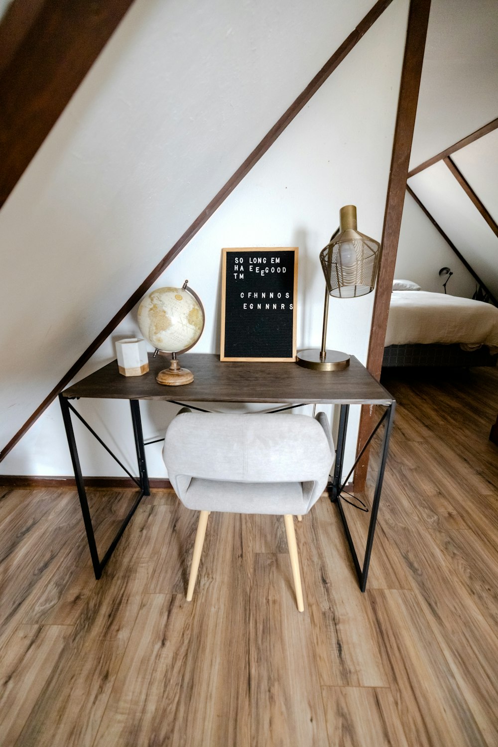 a table with a chair and a lamp on it