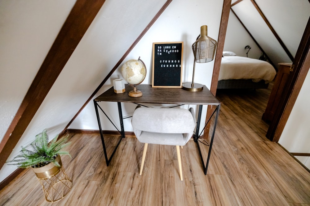 a table with a chair and a lamp on it