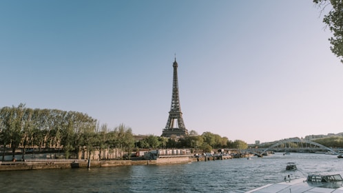 a body of water with a tower in the background