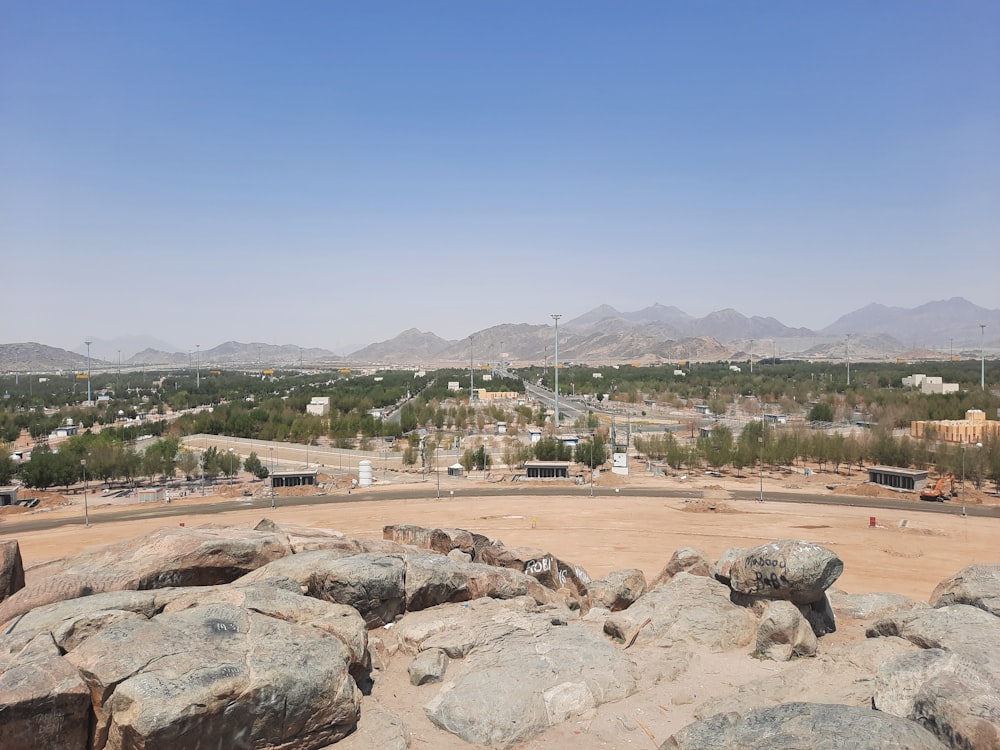 a rocky area with a city in the background