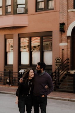 A friendly real estate agent showing an apartment to a happy couple.