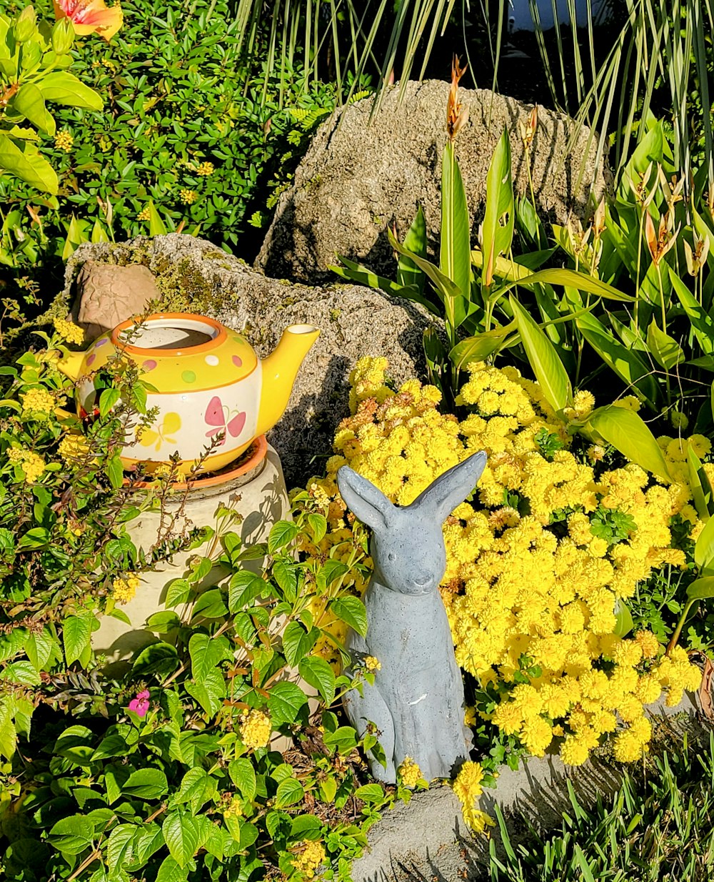 a statue of a rabbit in a garden