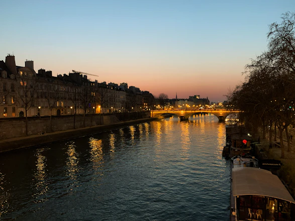 a river with a bridge and buildings along it