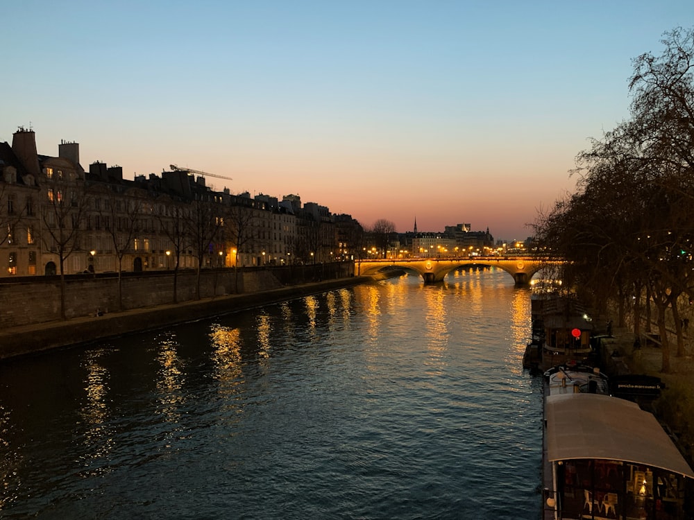 a river with a bridge and buildings along it