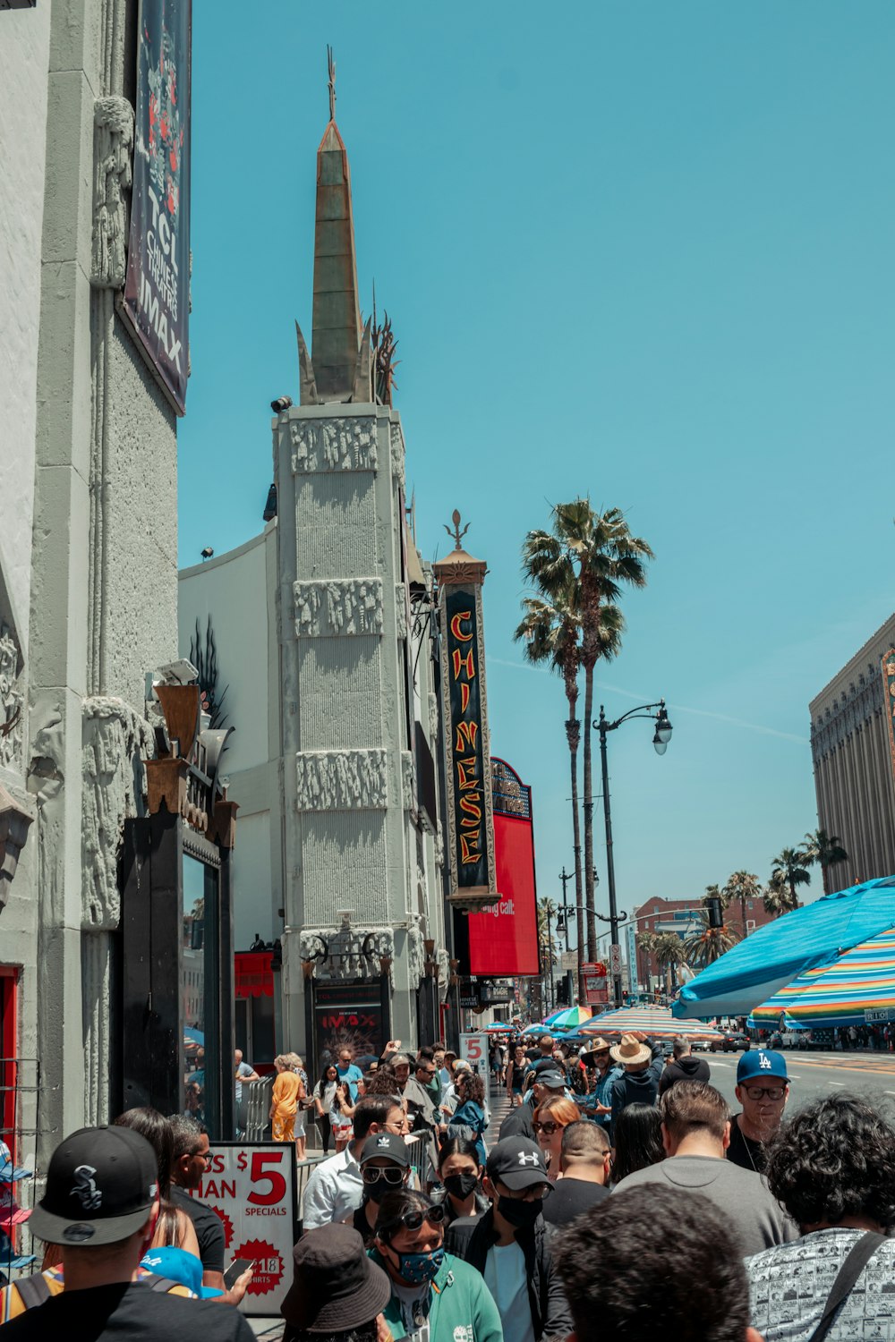 a crowd of people in front of a tall building