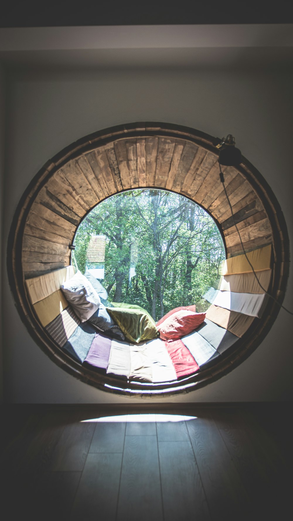 a mirror showing a person sitting on a bench