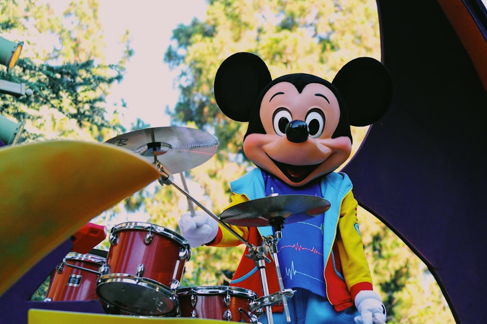 a person in a garment playing drums