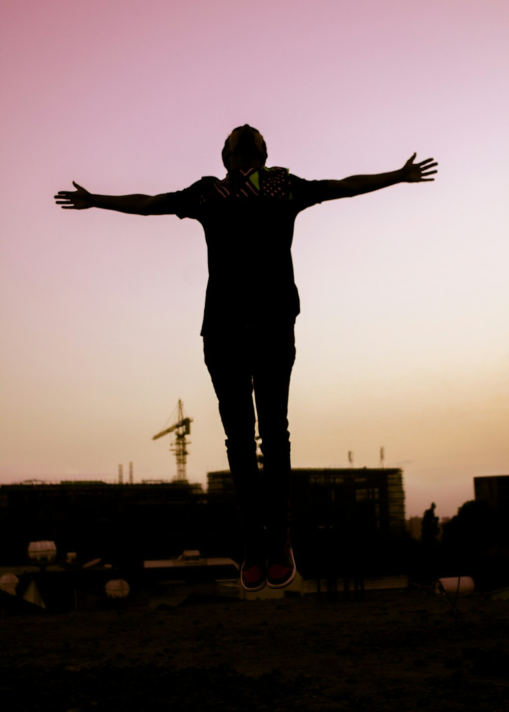 a man standing in front of a sunset