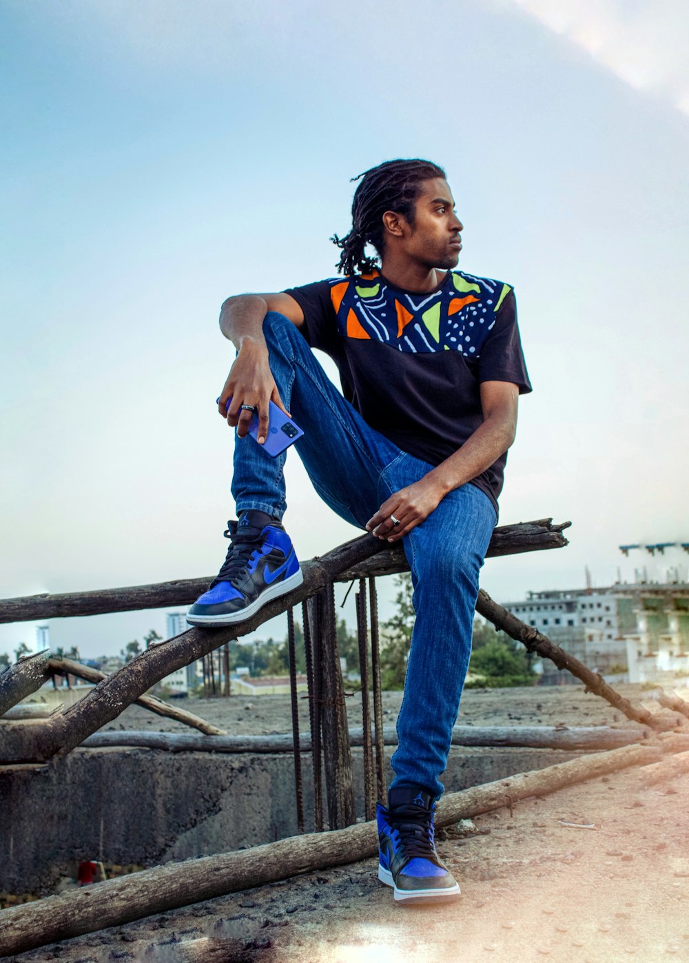 a man sitting on a railing