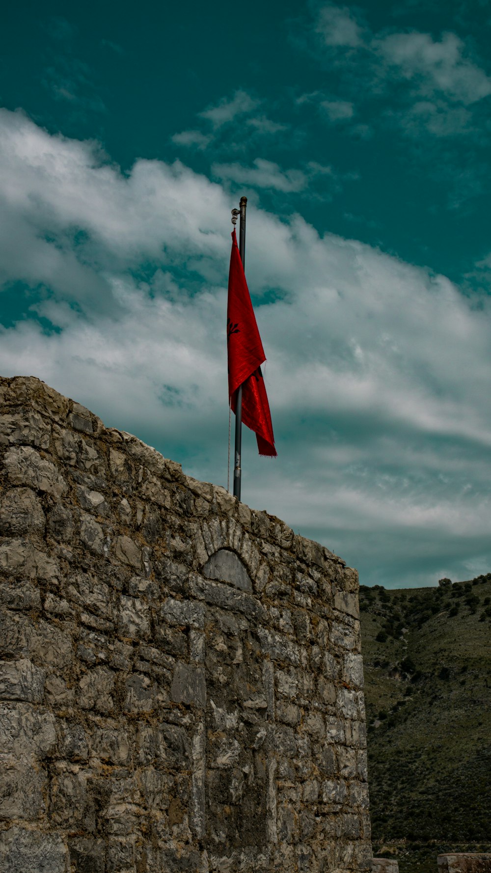 a flag on a stone wall