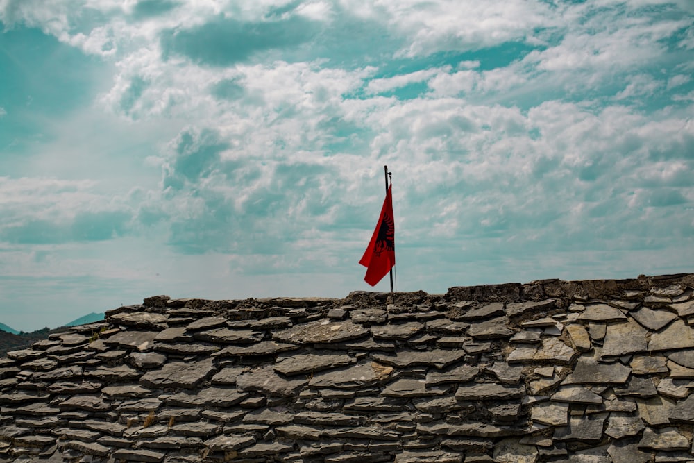 a flag on a stone wall