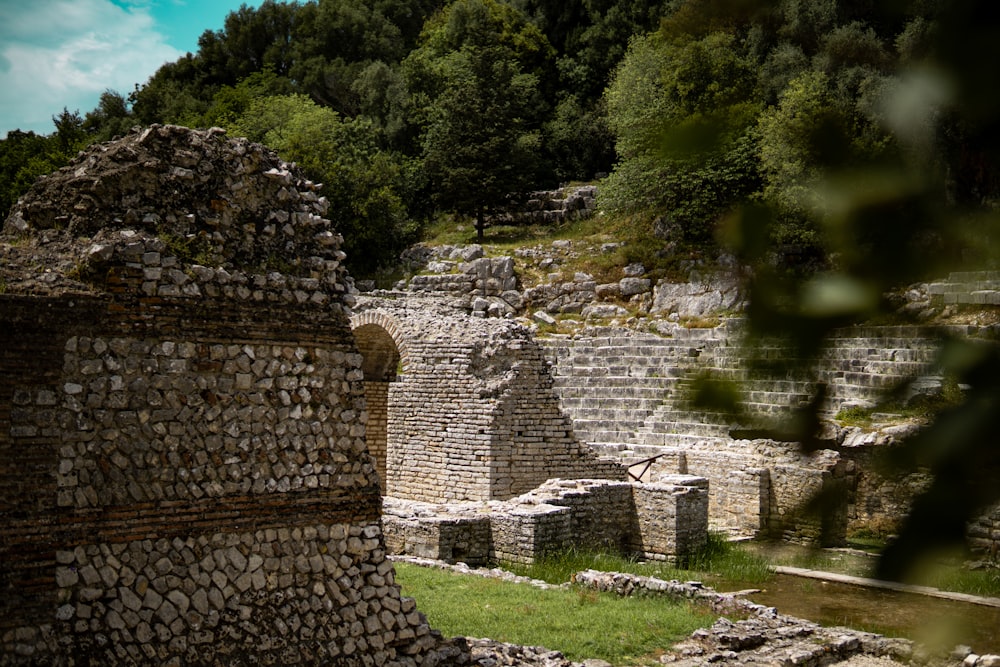 a stone wall with trees in the background