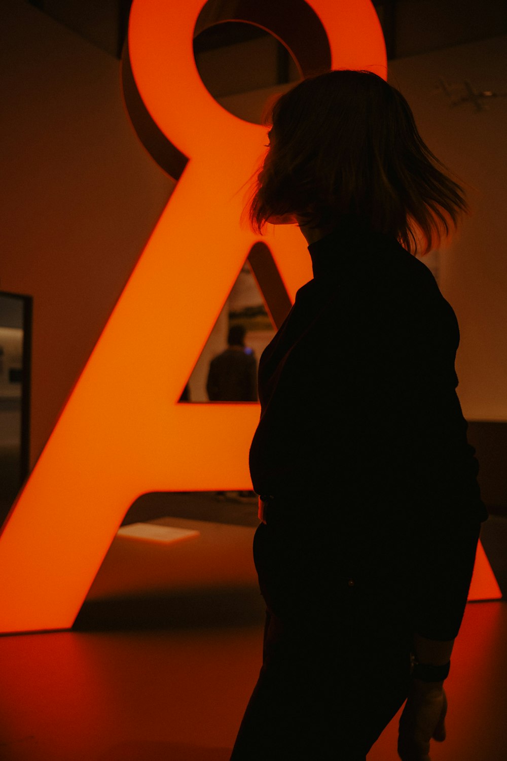 a man standing in front of a sign