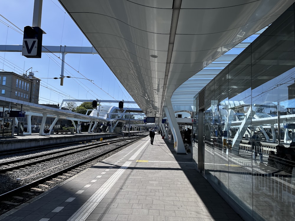 a train station with a person walking