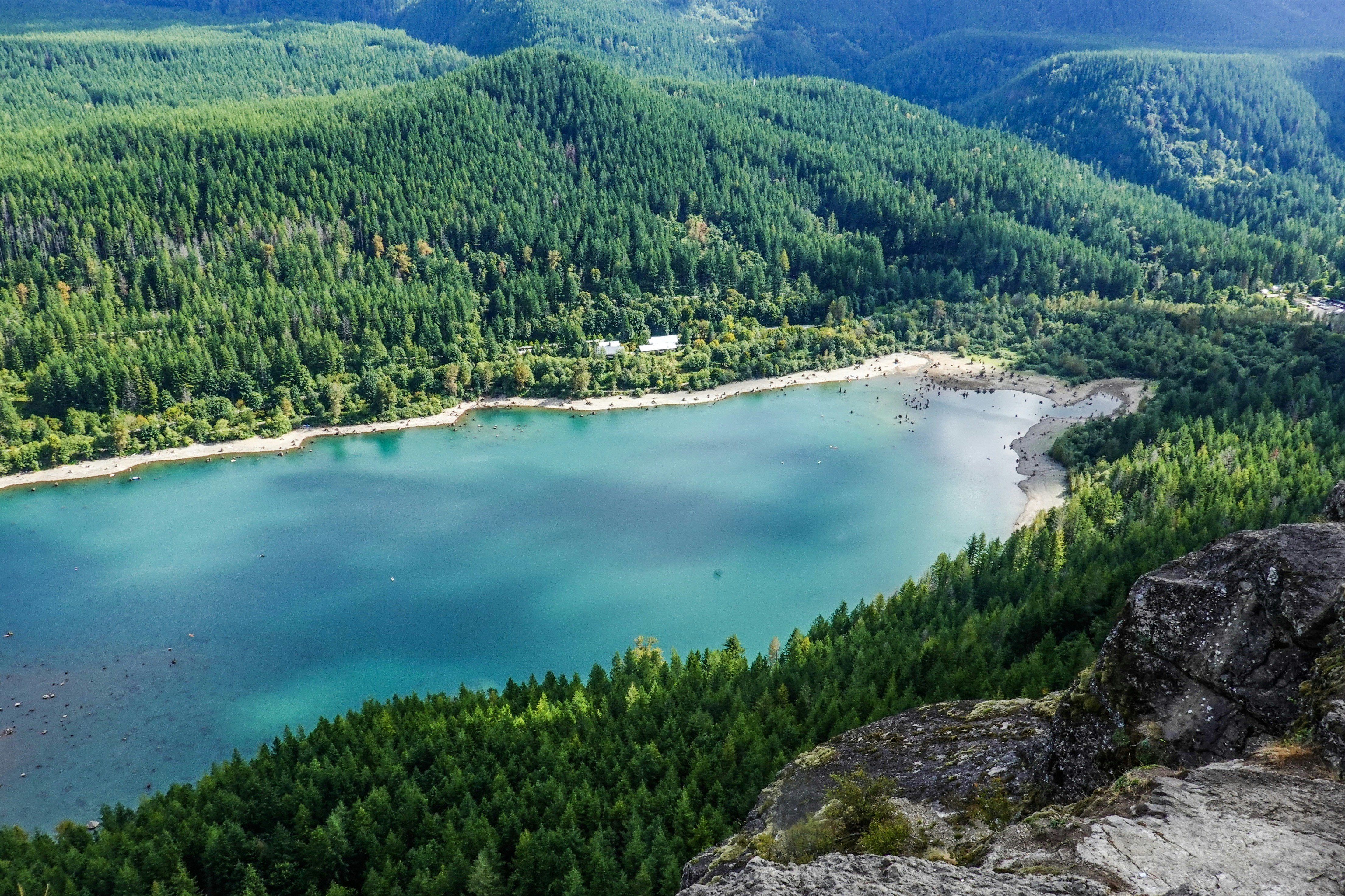 a lake surrounded by trees and mountains
