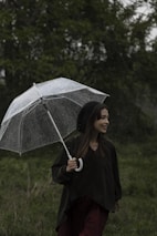 A happy customer using an umbrella during a light rain.