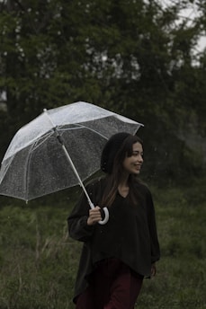 A happy customer using an umbrella during a light rain.