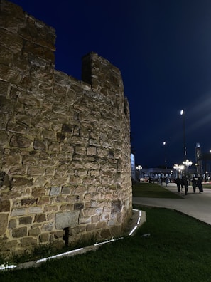 Evening view of a retaining wall illuminated by soft garden lighting, highlighting craftsmanship.