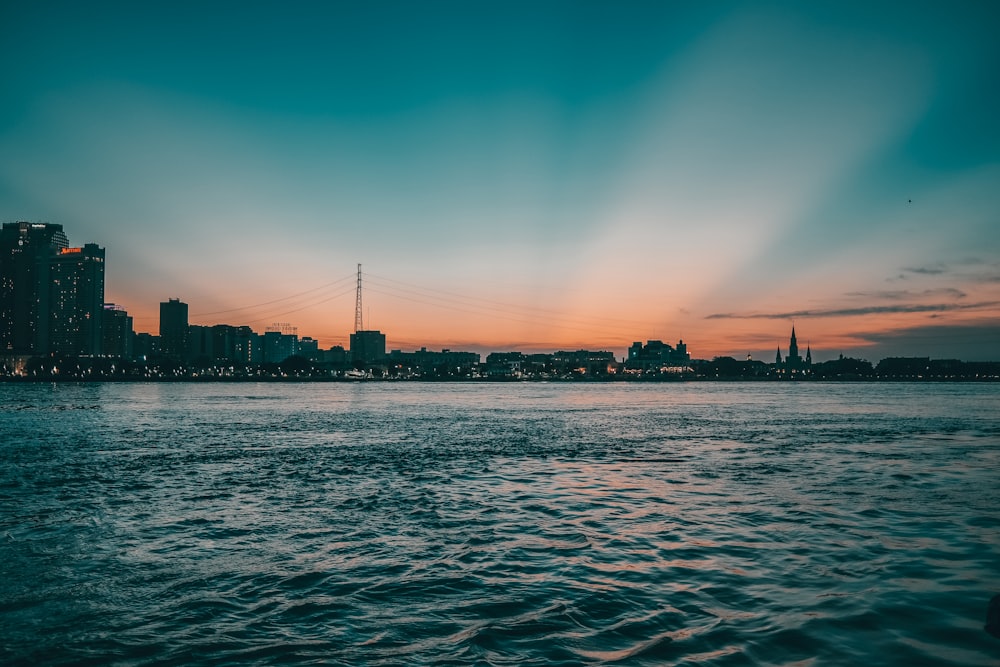 a body of water with a city in the background