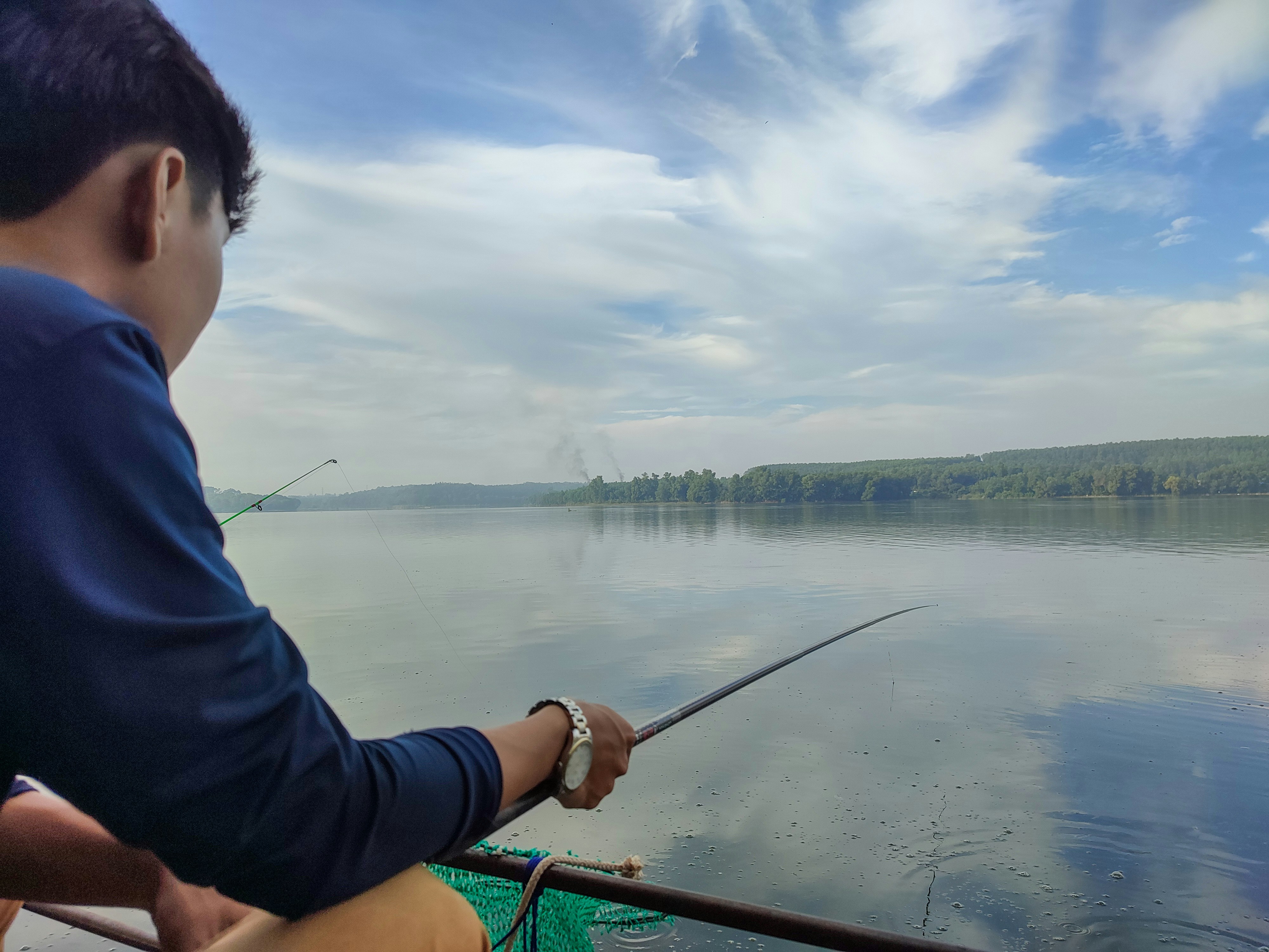 a man fishing on a boat