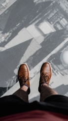 a pair of feet with sandals on a patterned surface