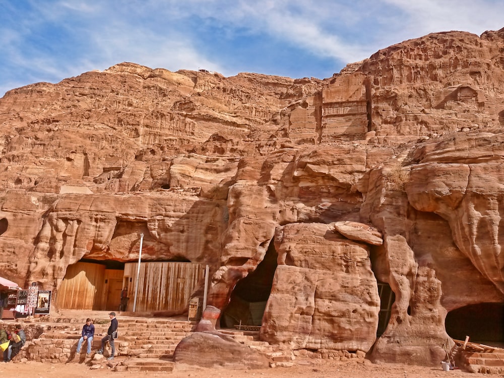 a large rock formation with Petra in the background