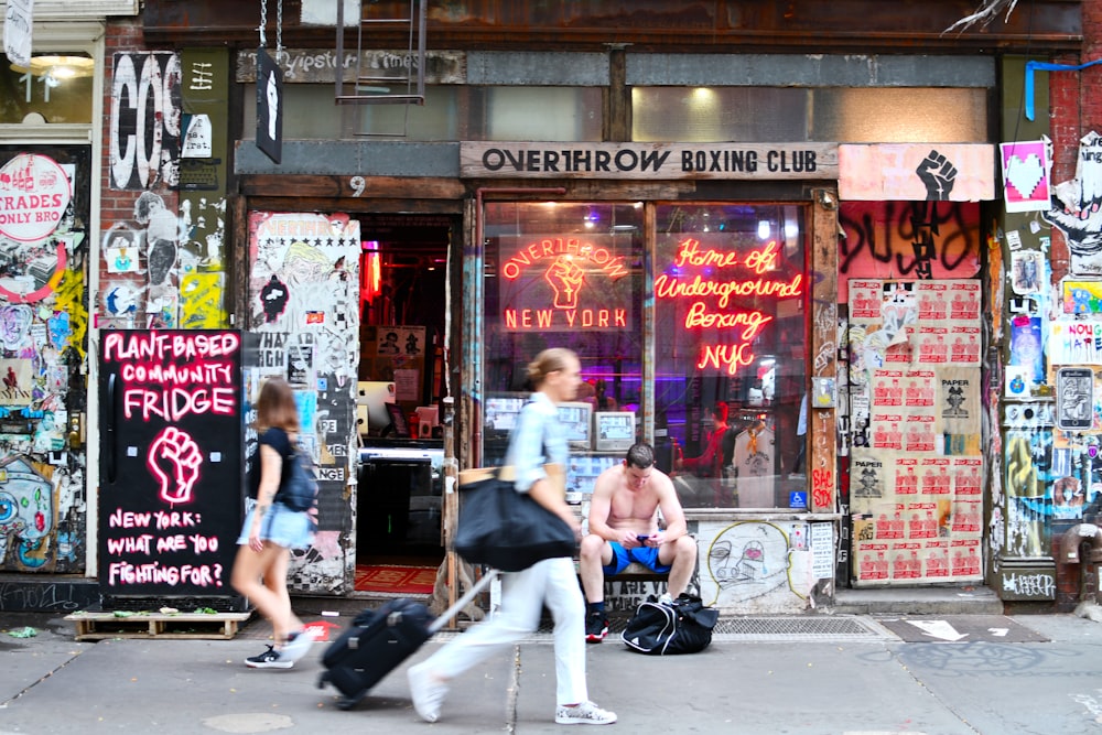 a group of people sit outside a store