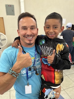 a person and a boy posing for a picture